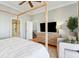 Bright main bedroom features a four-poster bed, television, and ensuite bathroom access at 68 W 9Th St # B, Folly Beach, SC 29439