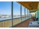 Inviting screened porch with comfortable seating and panoramic marina views, perfect for relaxation and entertaining at 68 W 9Th St # B, Folly Beach, SC 29439