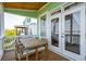 Covered porch showcasing an outdoor dining area, creating a perfect spot for enjoying meals with a scenic backdrop at 68 W 9Th St # B, Folly Beach, SC 29439