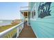 Charming covered porch with a view of the marina, perfect for relaxation and outdoor enjoyment at 68 W 9Th St # B, Folly Beach, SC 29439