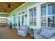 Cozy covered porch with comfortable seating, ideal for enjoying outdoor living and relaxation at 68 W 9Th St # B, Folly Beach, SC 29439