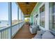 Spacious porch with comfortable seating options, offering a serene retreat with water views and coastal breezes at 68 W 9Th St # B, Folly Beach, SC 29439