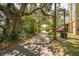 Neighborhood street view surrounded by mature oak trees and lush greenery at 68 W 9Th St # B, Folly Beach, SC 29439