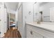 Bathroom vanity with a white countertop and modern fixtures; view to bedroom at 700 Daniel Ellis Dr # 3208, Charleston, SC 29412