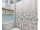Well-maintained bathroom with a patterned shower curtain and built-in shelving for storage at 700 Daniel Ellis Dr # 3208, Charleston, SC 29412