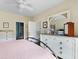 Bedroom with a white dresser, ceiling fan, and adjacent bathroom at 700 Daniel Ellis Dr # 3208, Charleston, SC 29412