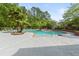 Community swimming pool with comfortable lounge chairs surrounded by lush landscaping at 700 Daniel Ellis Dr # 3208, Charleston, SC 29412