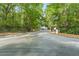 Community entrance gate with a paved road surrounded by lush greenery at 700 Daniel Ellis Dr # 3208, Charleston, SC 29412