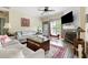 Comfortable living room with a fireplace, ceiling fan, and access to the outdoor balcony at 700 Daniel Ellis Dr # 3208, Charleston, SC 29412