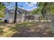 Backyard featuring well-maintained landscaping and an inviting screened-in porch at 8363 Water Ash Way, North Charleston, SC 29420