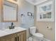 Bathroom featuring a wood framed mirror, modern vanity, and a window for natural light at 8363 Water Ash Way, North Charleston, SC 29420