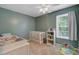 Cozy bedroom featuring neutral-toned walls, plush carpeting, and a bright white ceiling fan at 8363 Water Ash Way, North Charleston, SC 29420