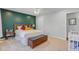 Well-lit bedroom with ample natural light, neutral carpet, and green accent wall at 8363 Water Ash Way, North Charleston, SC 29420