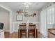 Dining area with a dark wood table, shelving, and sheer window curtains at 8363 Water Ash Way, North Charleston, SC 29420