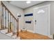 Charming entryway with wood floors, coat hooks and a staircase with decorative iron railing at 8363 Water Ash Way, North Charleston, SC 29420