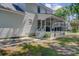 Exterior view of the screened-in back porch with access to the yard at 8363 Water Ash Way, North Charleston, SC 29420