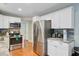 Bright kitchen features stainless steel appliances, hardwood floors, and white cabinets at 8363 Water Ash Way, North Charleston, SC 29420