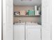 Convenient laundry closet featuring washer and dryer with storage shelves above for supplies at 8363 Water Ash Way, North Charleston, SC 29420