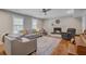 Bright living room with hardwood floors, fireplace, and large windows offering natural light at 8363 Water Ash Way, North Charleston, SC 29420