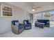 Relaxing screened-in porch with comfortable seating and ceiling fan at 8363 Water Ash Way, North Charleston, SC 29420