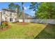 Well-kept backyard with green lawn and a white picket fence at 8956 N Red Maple Cir, Summerville, SC 29485