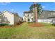 Spacious backyard featuring a lush lawn, garden, and privacy fence at 8956 N Red Maple Cir, Summerville, SC 29485