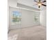 Sunlit room features plush carpet, natural light, and views of the surrounding greenery at 8956 N Red Maple Cir, Summerville, SC 29485
