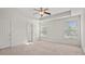 Spacious carpeted bedroom with bright windows and a ceiling fan at 8956 N Red Maple Cir, Summerville, SC 29485