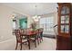 Elegant dining room featuring a polished wood table, chandelier, and traditional china cabinet at 8956 N Red Maple Cir, Summerville, SC 29485