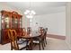 Bright dining room with a polished table, chairs, and antique wooden hutch at 8956 N Red Maple Cir, Summerville, SC 29485