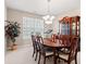 Elegant dining room with a large wooden table, chairs, and a decorative china cabinet at 8956 N Red Maple Cir, Summerville, SC 29485