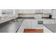 Clean kitchen featuring white cabinets, stainless steel sink, and a smooth black countertop at 8956 N Red Maple Cir, Summerville, SC 29485