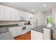 Modern kitchen with white cabinets, stainless appliances, and a view of the neighborhood at 8956 N Red Maple Cir, Summerville, SC 29485
