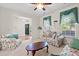 Comfortable living room featuring sofas and natural light streaming through the windows at 8956 N Red Maple Cir, Summerville, SC 29485