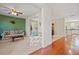 Bright living room flowing into dining area with hardwood floors and comfortable floral sofa set at 8956 N Red Maple Cir, Summerville, SC 29485