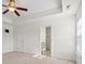 Spacious main bedroom features neutral carpeting, en-suite bath, ceiling fan and recessed lighting at 8956 N Red Maple Cir, Summerville, SC 29485