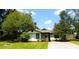 Charming single-story home with mature trees, well-manicured lawn, and a long concrete driveway at 95 Logan Dr, Summerville, SC 29483