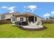 Spacious backyard featuring a stone patio, pergola, and well-manicured landscaping at 9781 Roseberry St, Ladson, SC 29456