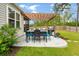Outdoor dining area featuring a stone patio, grill, and a pergola perfect for entertaining at 9781 Roseberry St, Ladson, SC 29456