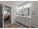 Bright bathroom featuring a double sink vanity, modern lighting, and a view of the bedroom at 9781 Roseberry St, Ladson, SC 29456