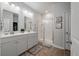 The bright bathroom features dual sinks, a walk-in shower, and ample storage, offering a spa-like experience at 9781 Roseberry St, Ladson, SC 29456