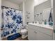 Charming bathroom with blue floral accents, a shower, and a modern vanity setup at 9781 Roseberry St, Ladson, SC 29456