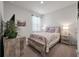 Cozy bedroom with a full-size bed, wooden furniture, and soft, natural lighting at 9781 Roseberry St, Ladson, SC 29456