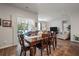 A spacious dining room with hardwood floors and a sliding glass door with backyard access at 9781 Roseberry St, Ladson, SC 29456