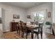 A dining room with wood floors that flow into a sliding glass door for easy access to an outdoor patio at 9781 Roseberry St, Ladson, SC 29456