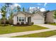 Lovely home with manicured front lawn, walkway, driveway, and attached garage at 9781 Roseberry St, Ladson, SC 29456
