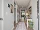 Inviting hallway with hardwood floors, stylish decor, leading to living area at 9781 Roseberry St, Ladson, SC 29456