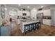 Well-lit kitchen with granite countertops, stainless steel appliances, and seating at the island at 9781 Roseberry St, Ladson, SC 29456