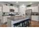 Modern kitchen with granite countertops, stainless steel appliances, and an island with seating for four at 9781 Roseberry St, Ladson, SC 29456