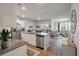 Open-concept kitchen with granite countertops, stainless steel appliances, and seamless flow to the living area at 9781 Roseberry St, Ladson, SC 29456
